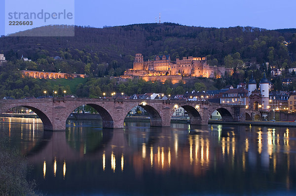 Neckische Brücke über Fluss beleuchtet bei Dämmerung  Fluss Neckar  Heidelberg  Deutschland