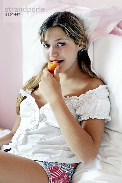 Girl eating apricot