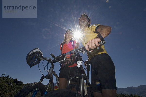 Austria  Salzburger Land  Couple on mountain bikes laughing