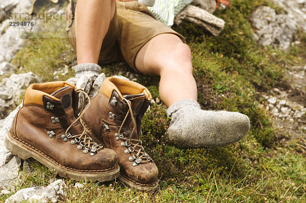 Austria  Salzburger Land  hiking boots and laying man