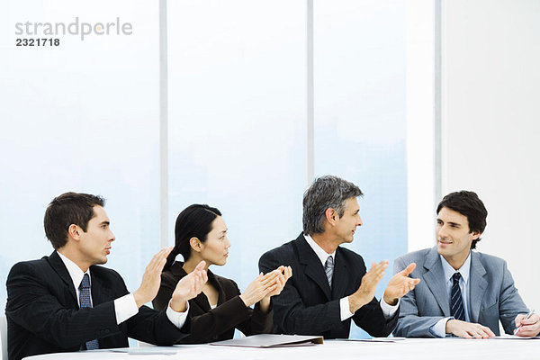Executives applaudieren männlichen Kollegen während des Treffens