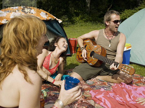 Drei Leute singen zusammen im Camp
