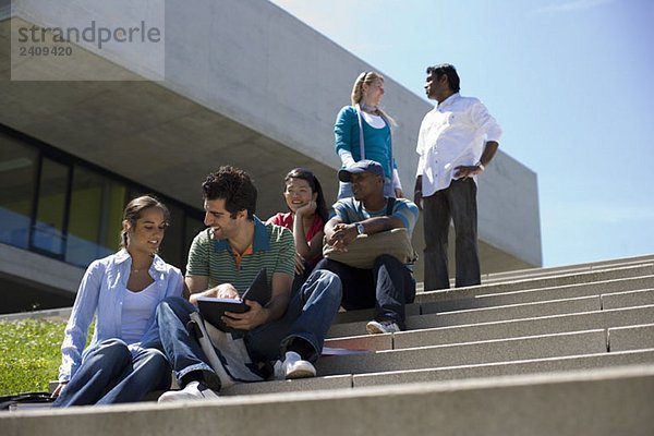 Studenten treffen sich und studieren auf der Freilufttreppe des Campus