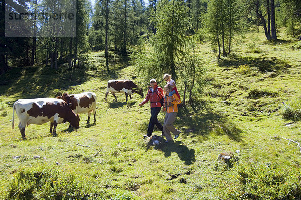 Austria  Salzburger Land  couple with daughter (6-7) hiking