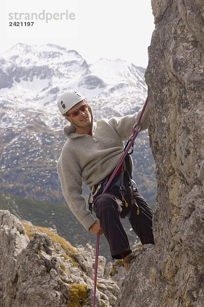 Austria  Salzburger Land  Man climbing on rock face