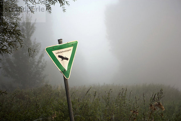 Germany  Nature Reserve Sign  Morning mist in the forest