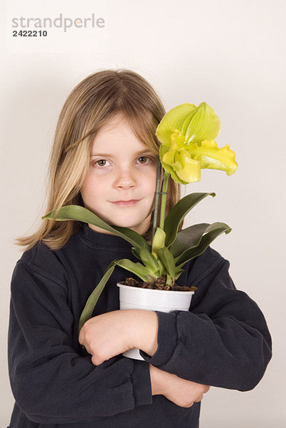 Blondes Mädchen (10-11) mit Topfpflanze  Portrait