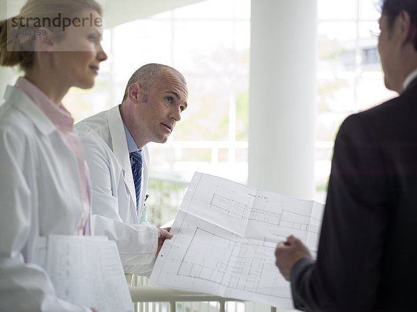 Architekt discussing Blueprint mit Ärzten