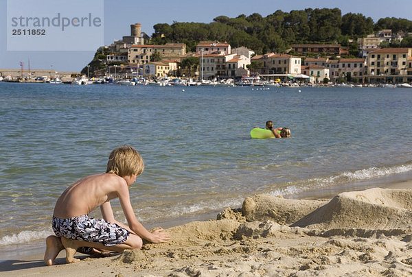 Italy  Elba  Marina di Campo  boy playing on beach