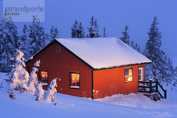 La Nictale shelter and snow-covered trees at twilight  Quebec  Canada