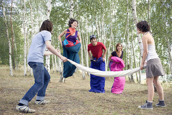 Germany  Friends having a sack race