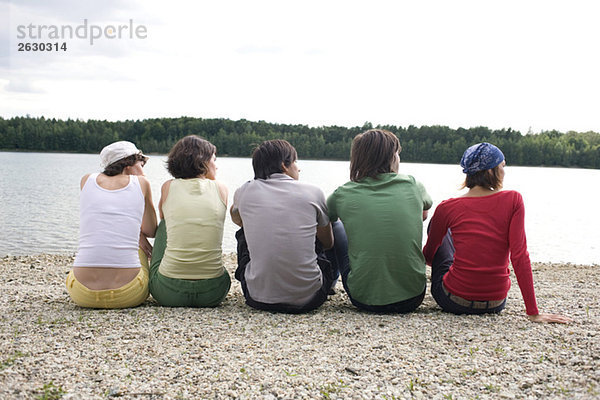 Germany  Leipzig  Ammelshainer See  Five persons sitting near lake