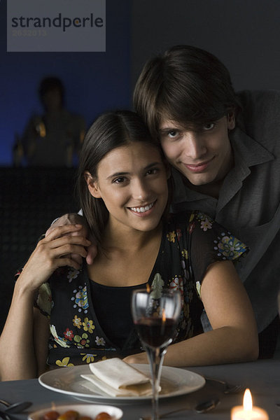 Portrait des Paares im Restaurant  Händchen haltend  lächelnd vor der Kamera