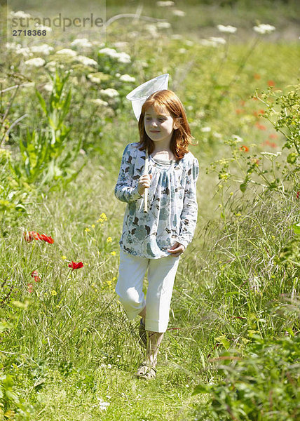 Junges Mädchen im Feld mit Schmetterlingsnetz