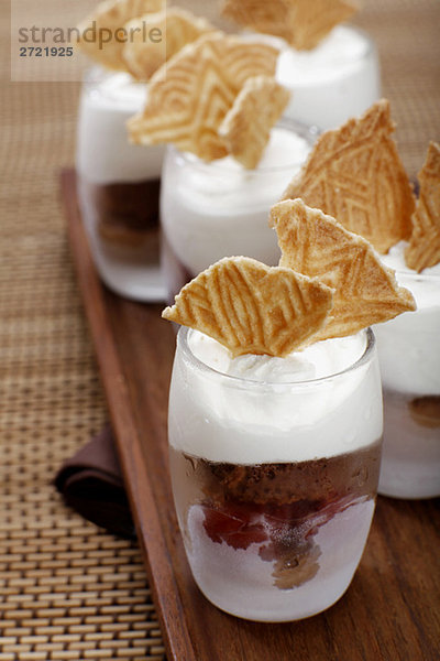 Chocolate ice cream with cherries  whipped chream and ice wafer