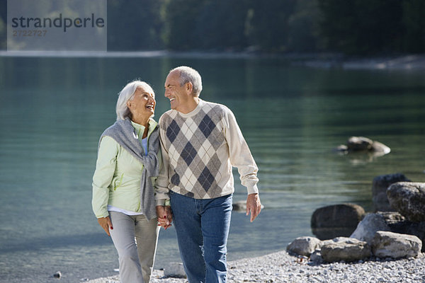 Germany  Bavaria  Walchensee  Senior couple walking across lakeshore