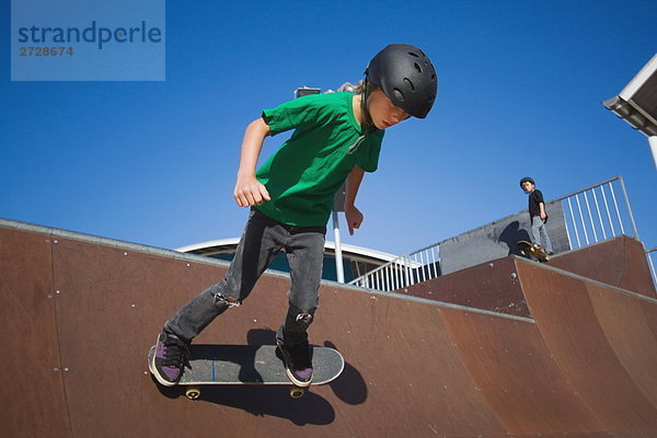 Boy skateboarding in Skate-park