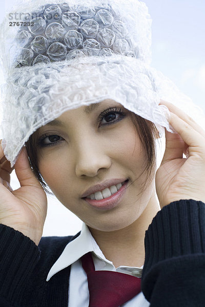 Junge Frau mit Hut aus Luftpolsterfolie  Portrait