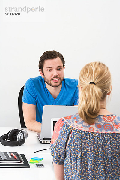 Eine Frau und ein Mann in einem Büro Schweden.