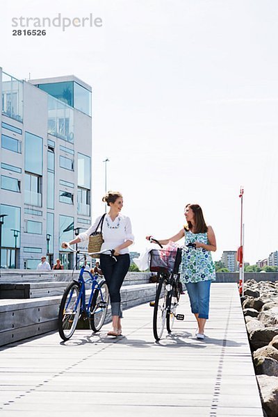 Zwei Frauen fahren Fahrrad Skane Schweden.