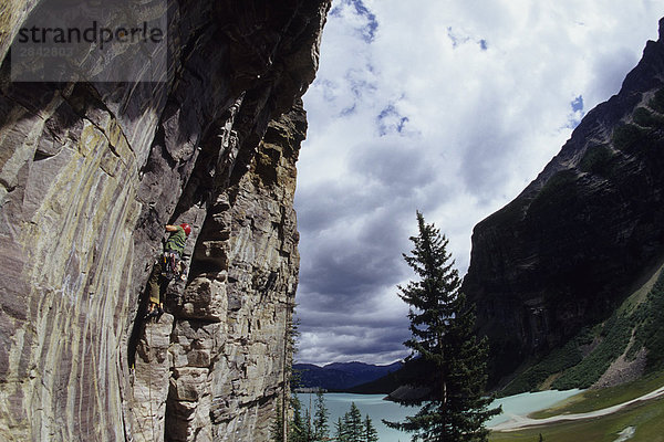 Ein Kletterer Arbeit seinen Weg bis eine Route mit Blick auf den schönen Lake Louise  Alberta  Kanada.