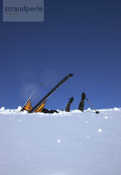 Skifahrer Kopf unten im Schnee
