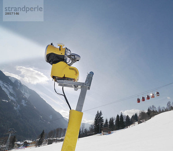 Schneefräse und Seilbahn im Skigebiet