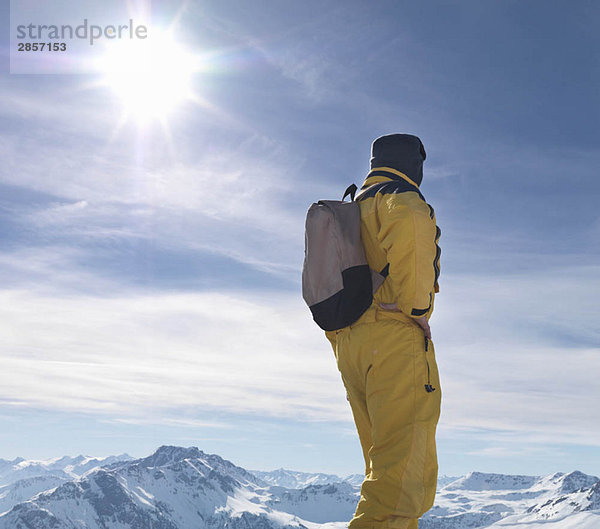 Mann auf dem Berggipfel stehend