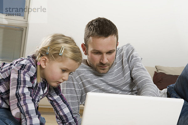 Vater und Tochter (3-4) mit Laptop