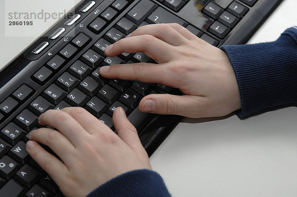 Jungenhand mit PC-Tastatur  erhöhte Ansicht