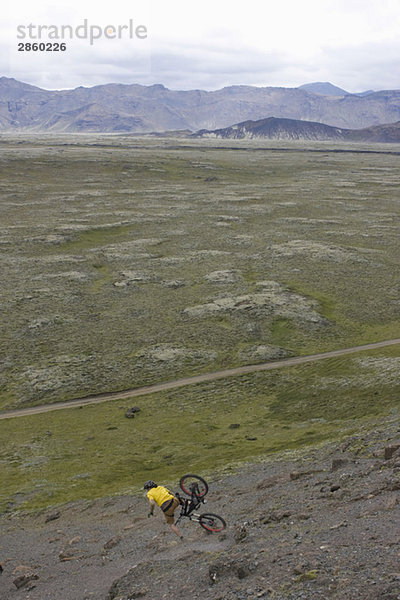 Iceland  Man mountain biking downhill