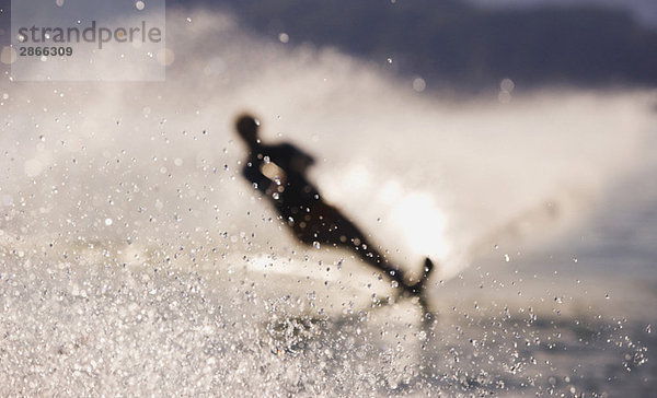 Austria  Salzkammergut  Lake Mondsee  Water-skier  silhouette (blurred motion)