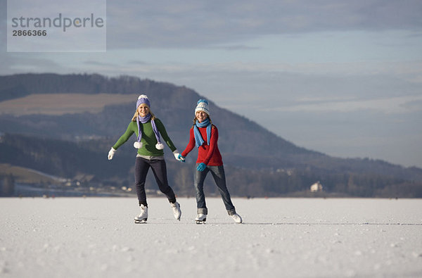 Austria  Salzkammergut  Lake Irrsee  Female teenagers (14-15) skating