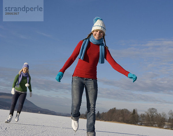 Austria  Salzkammergut  Lake Irrsee  Female teenagers (14-15) skating