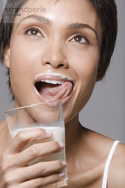 Nahaufnahme einer Frau  die Milch aus einem Glas trinkt