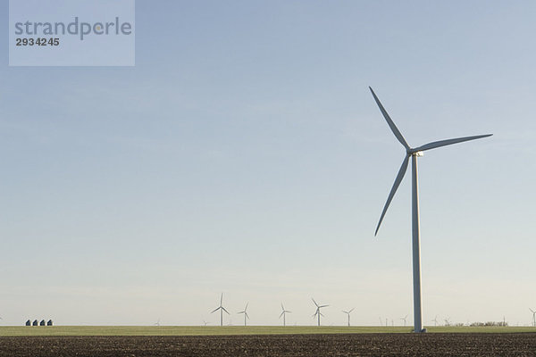 Steel graineries dwarfed by array of wind turbines