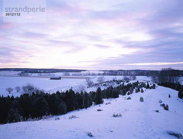 Winterlandschaft mit einer Scheune im Hintergrund