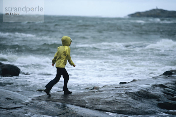 Eine Frau im Wind am Meer Schweden.