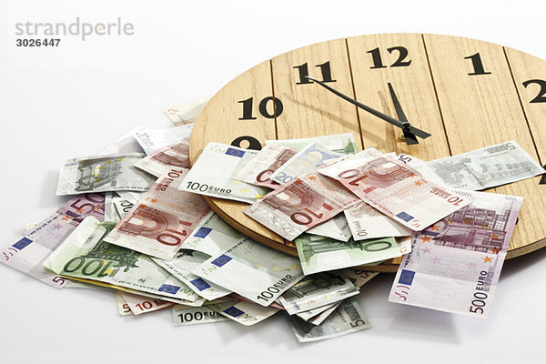 Euro bank notes and clock  symbol for time is money