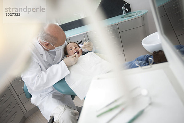 Dentist examining girl (8-9)