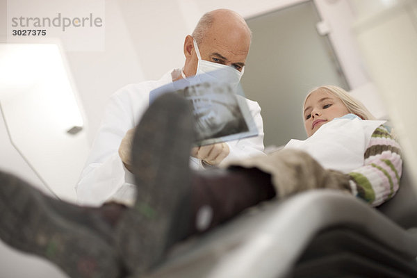 Zahnarzt zeigt Mädchen (8-9) und X-Ray