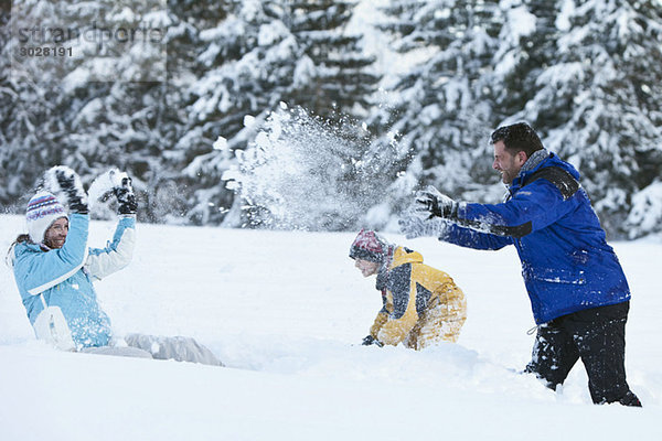 Germany  Bavaria  Family having snowball fight