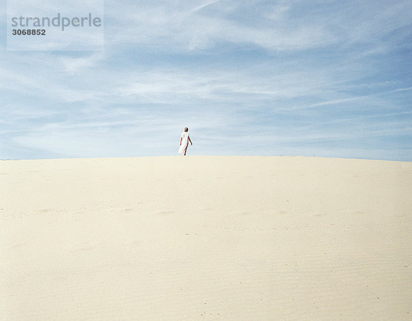 Frau auf Sand stehend  in der Ferne