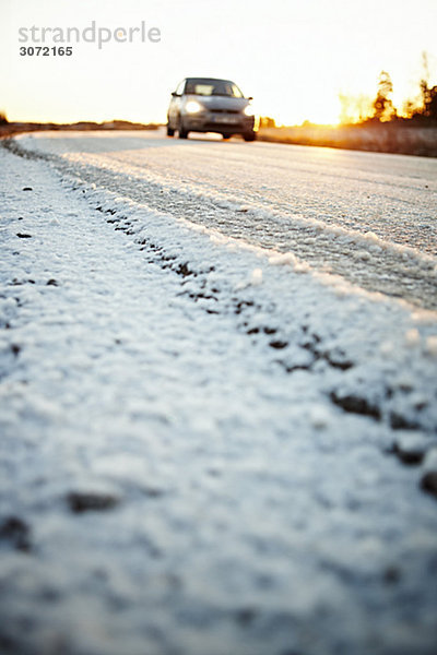 Eine winterliche Straße bei sunset Sweden.