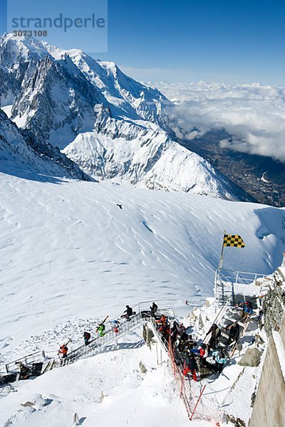 Skiers going down the steps Grand montets Chamonix France.