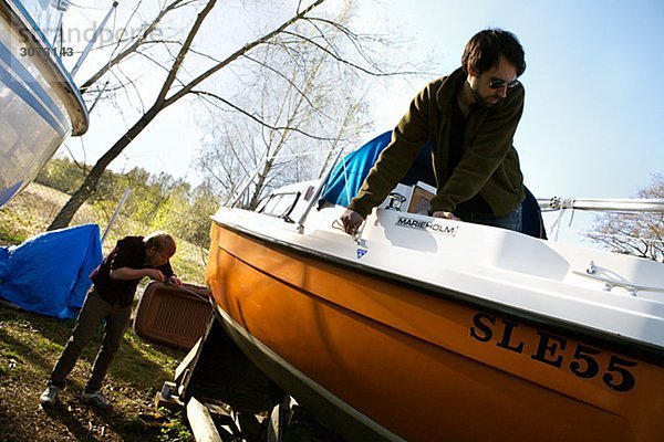 Two men and a sailing-boat Sweden.