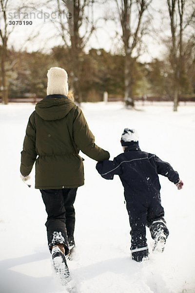 Mother and boy playing in the snow Gotland Sweden.