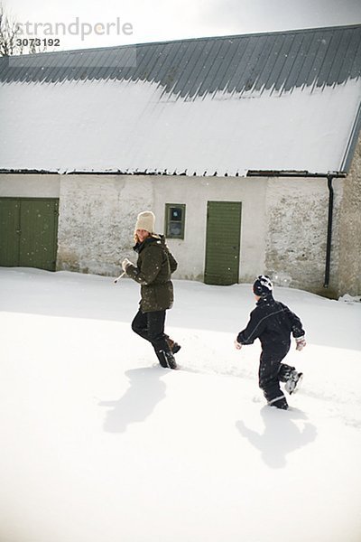 Mother and boy playing in the snow Gotland Sweden.