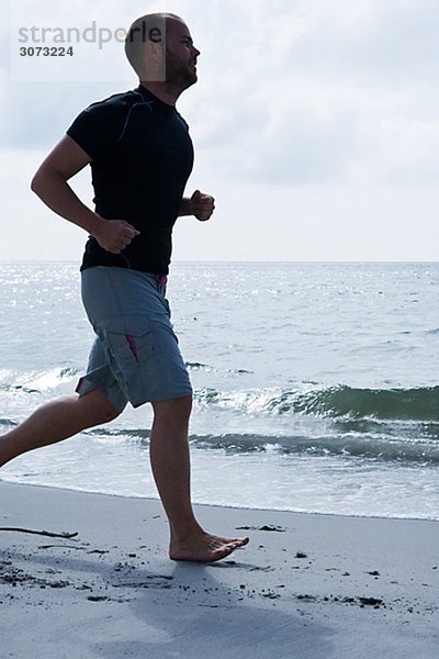 A man jogging by the sea Sweden.