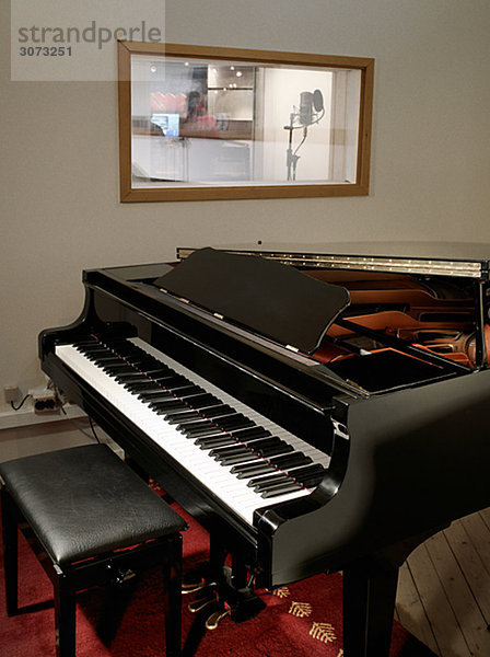 A grand piano in a music studio.